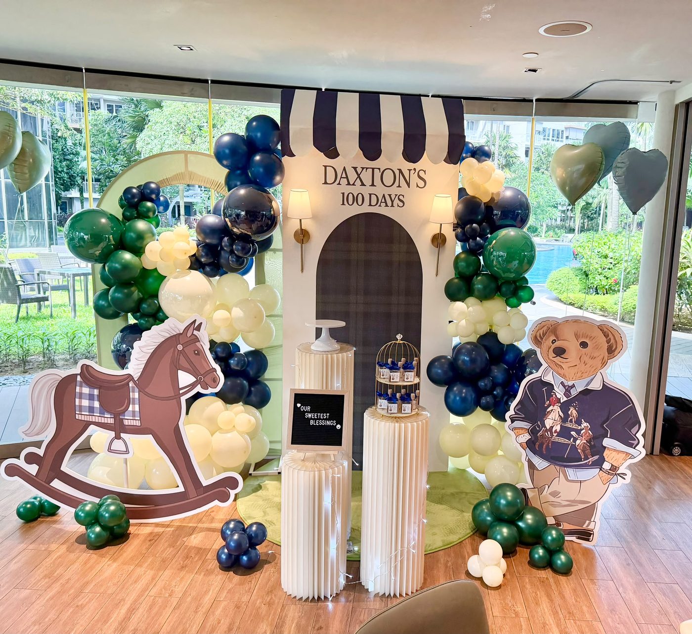 A balloon-garland celebration setup styled by LinkNow Events Co. for Daxton's 100 Days